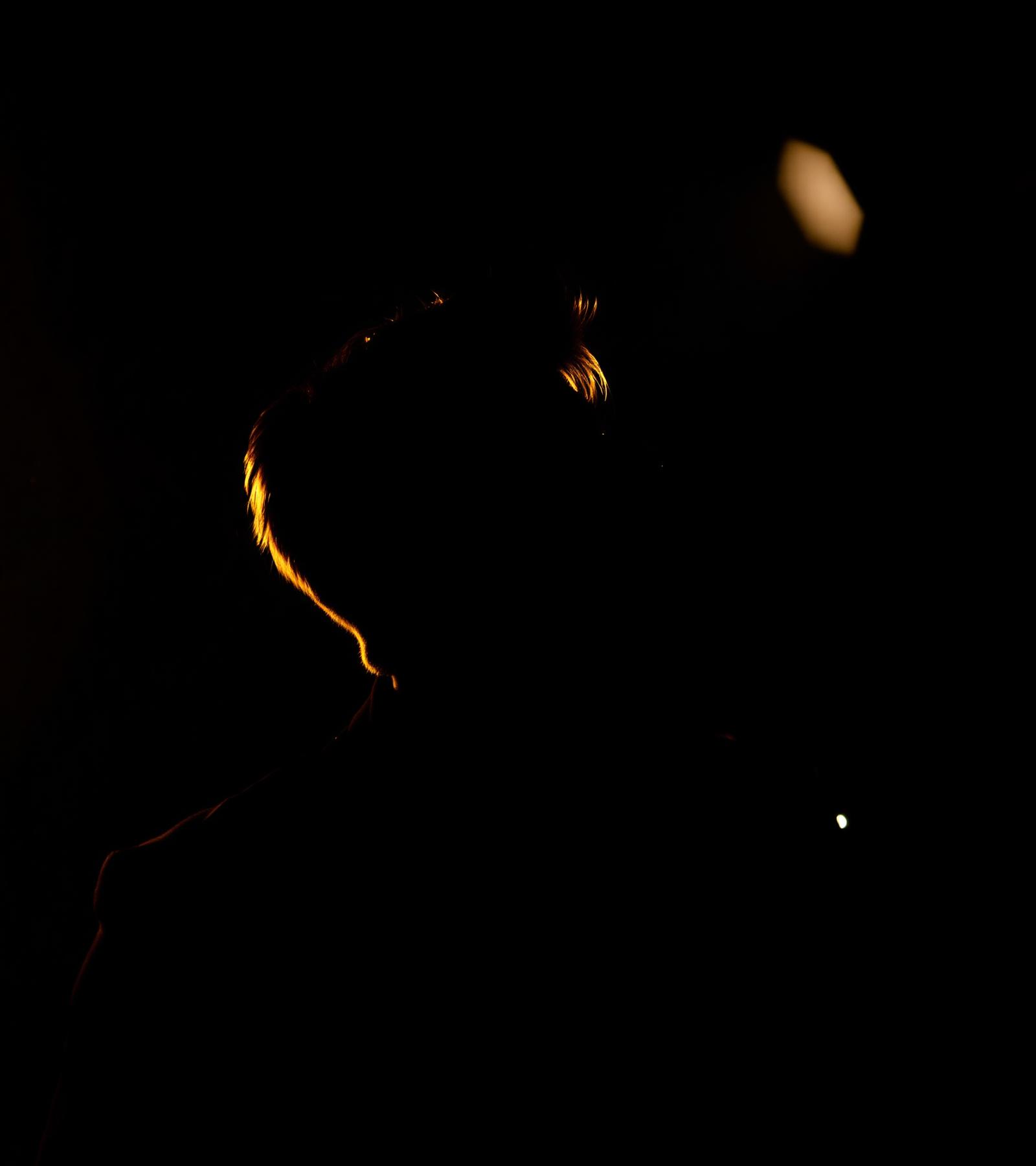 Artist recording in a low-lit studio